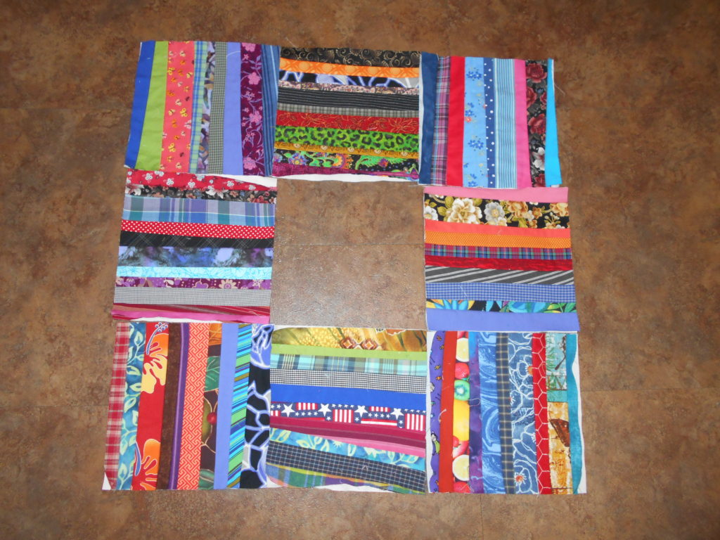 8 string quilt blocks done in a variety of colors