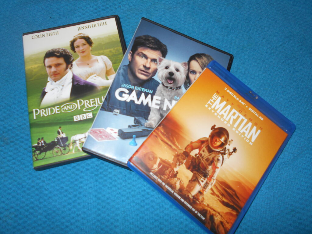 A display of three DVD cases: Pride and Prejudice, Game Night, The Martian.